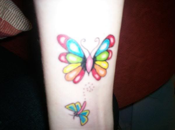 butterfly tattoo, tattoo on wrist. Colored butterfly tattoo design on wrist